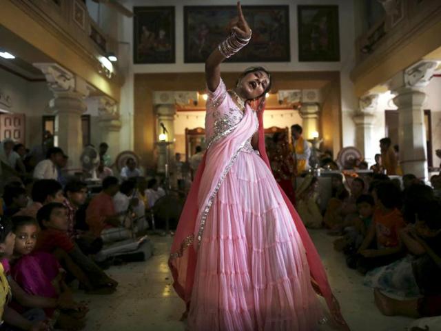 An Indian girl in traditional dress dances during the Janmashtami festival celebrations at a temple in New Delhi, India. Janmashtami is the festival that marks the birth of Hindu God Krishna.(AP/Kevin Frayer)