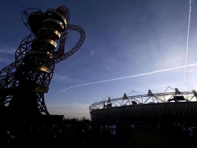 The sun sets behind the Olympic stadium before the Closing Ceremony of the 2012 Summer Olympics in London. (AP Photo/Andrew Medichini)