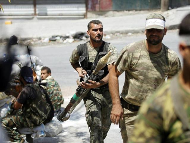 A Free Syrian Army fighter carries an RPG during clashes in Aleppo. Agencies