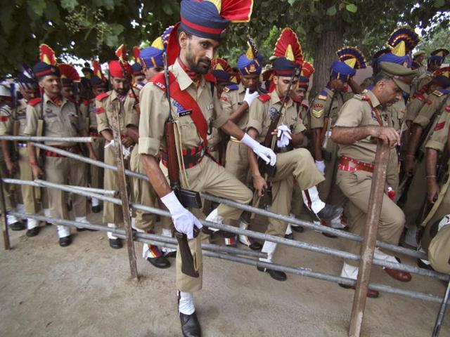 Jammu and Kashmir policemen walk after Independence Day celebration rehearsals in Jammu. AP Photo/Channi Anand