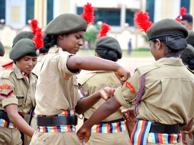 A girl cadet of NCC corrects the uniform of her colleague during dress rehearsal for Independence Day Parade, at Morabadi Grounds in Ranchi. Agency