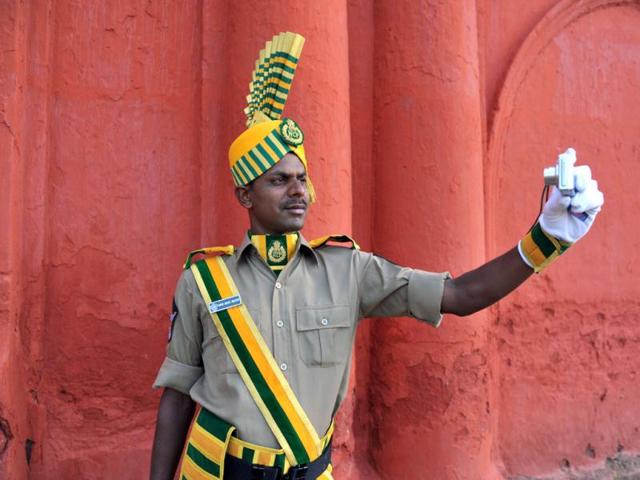 An Andhra Pradesh state Special Police officer takes a self portrait during a full dress rehearsal for Independence Day celebrations in Secunderabad. AFP photo/Noah Seelam