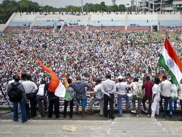 Supporters listen to yoga guru Baba Ramdev at Ambedkar stadium in New Delhi. AFP Photo/Prakash Singh