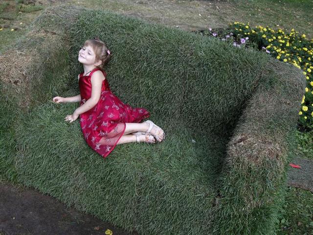 A girl lies on a couch that is covered with grass in a park in central Kiev. Reuters Photo