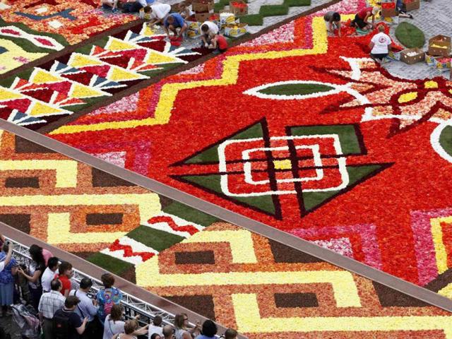 Gardeners design a giant flower carpet to form a floral decoration at Brussels' Grand Place. Reuters photo/Francois Lenoir