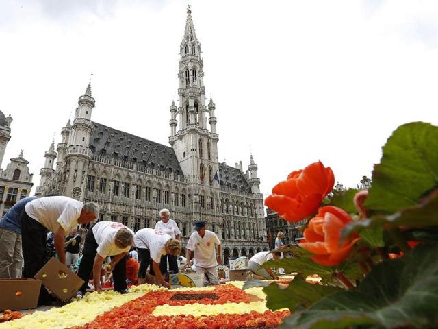Gardeners work on a giant carpet made of flowers to form a floral decoration at Brussels' Grand Place. Reuters photo/Francois Lenoir