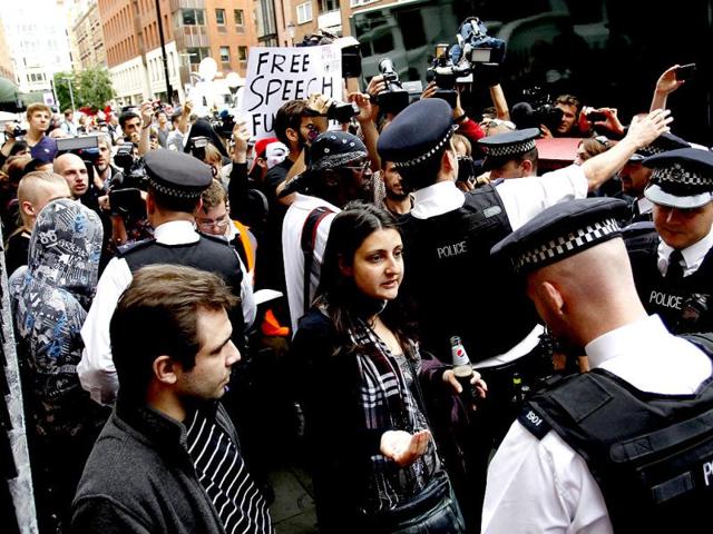 British police officers move the protesters in support of WikiLeaks founder Julian Assange from the front of the Ecuadorian Embassy in central London. AP/Sang Tan