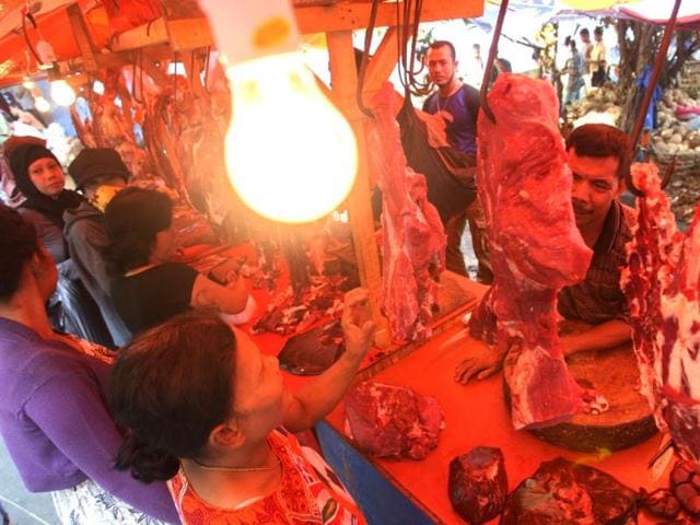Indonesian women buy meat in preparation for Eid ul-Fitr holiday at a market in Jakarta, Indonesia. (AP/Achmad Ibrahim)