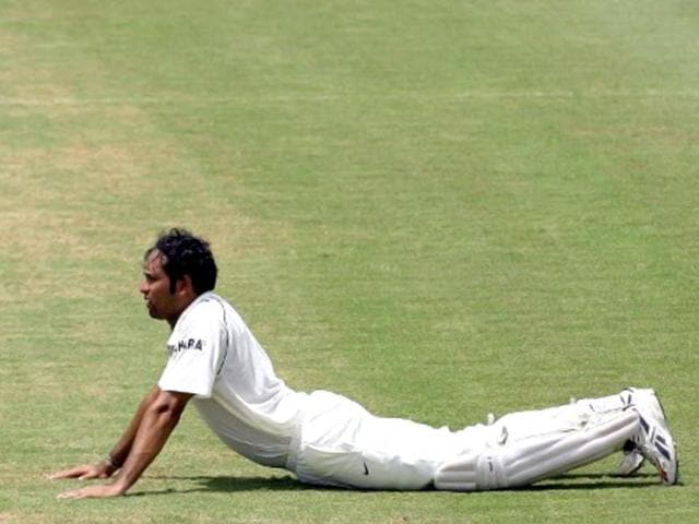 VVS Laxman stretches on the fourth day of the third test between West Indies and India at the Warner Park stadium in St Kitts, 25 June 2006. AFP photo/ Indranil Mukherjee