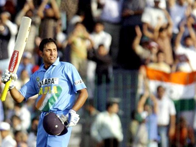 VVS Laxman raises his bat to acknowledge a cheering crowd after completing his century during the fifth and final ODI match between Pakistan and India at the Gaddafi stadium in Lahore, 24 March 2004. AFP photo/Aamir Qureshi
