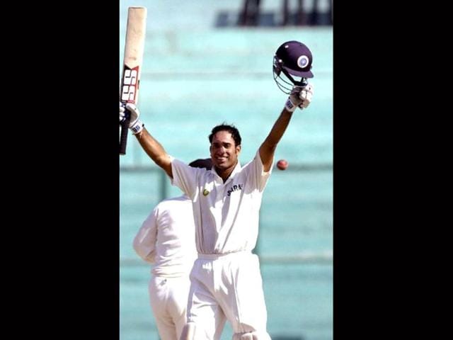 VVS Laxman celebrates his century on the final day of the second test match between India and New Zealand in Mohali, 20 October 2003. AFP photo/Raveendran