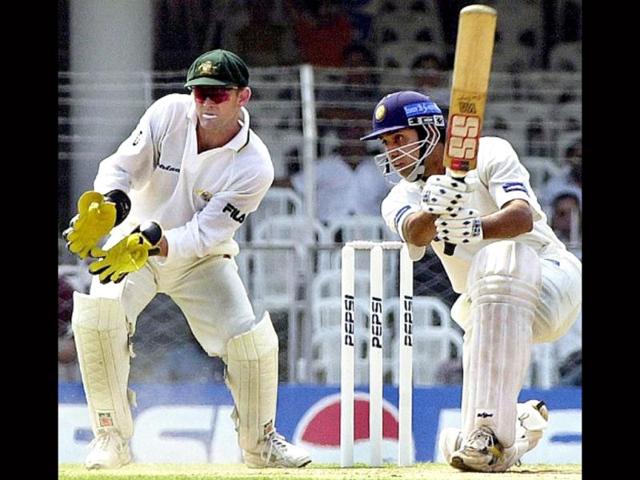 VVS Laxman smashes to the boundary as Australian wicketkeeper Adam Gilchrist (L) looks on during the second day of the first three-day match between India and Australia in Nagpur, 18 February 2001. AFP photo/Raveendran