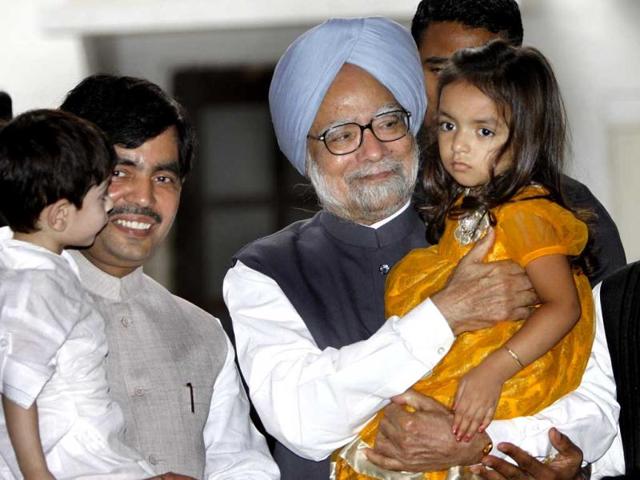 Prime Minister Manmohan Singh greets young family members of BJP MP Syed Shahnawaz Hussain during Eid celebrations at the latter's residence, in New Delhi on Monday. Photo: Sunil Saxena /Hindustan Times