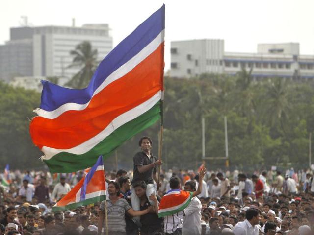 An activist of MNS waves a party flag during a protest rally at Azad Maidan in Mumbai. (Reuters/Vivek Prakash)