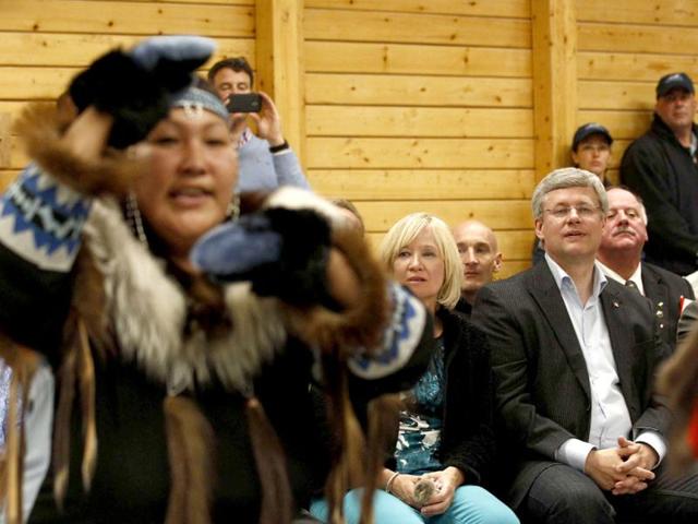 Canada's Prime Minister Stephen Harper (front R) and his wife Laureen watch dancers during a community feast in Cambridge Bay, Nunavu. Harper is on the third day of his annual tour of northern Canada. (Reuters)