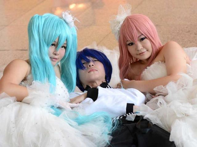 Fans pose for photographs during the four-day 2012 Animation and Comics Fair at the National Agricultural Exhibition Center in Beijing. AFP/Mark Ralston