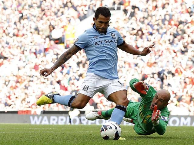 Manchester-City-s-Carlos-Tevez-shoots-past-Liverpool-s-Pepe-Reina-to-score-during-their-English-Premier-League-soccer-match-at-Anfield-in-Liverpool-northern-England-Reuters-Phil-Noble Manchester-City-s-Carlos-Tevez-shoots-past-Liverpool-s-Pepe-Reina-to-score-during-their-English-Premier-League-soccer-match-at-Anfield-in-Liverpool-northern-England-Reuters-Phil-Noble