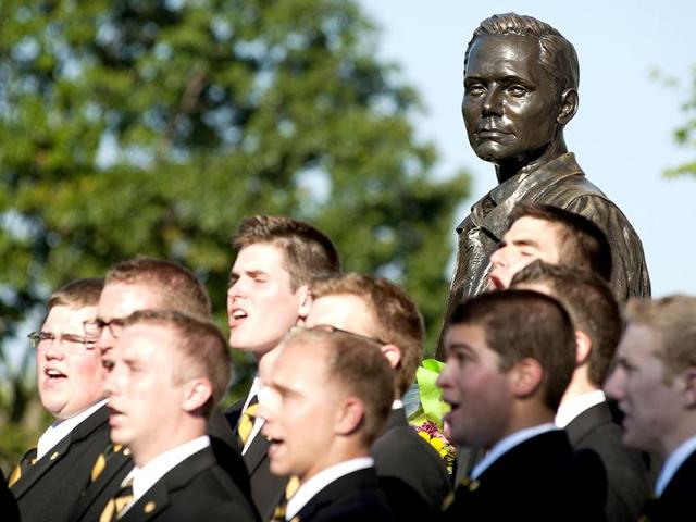 A statue of Neil Armstrong watches over the Glee Club as they sing during a memorial service for Armstrong in front of the Neil Armstrong Hall of Engineering at Purdue in West Lafayette. AP/Journal & Courier, Brent Drinkut