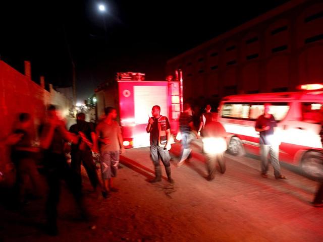 Ambulances and firemen arrive following an Israeli air strike in Gaza City. AFP/Mohammed Abed
