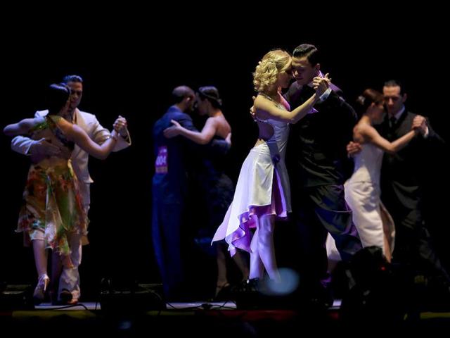 Russia's tango couple Dmitry Vasin, right, and Taya Finenkova compete during the 2012 Tango Dance World Cup salon finals in Buenos Aires, Argentina. Couples from around the world competed in the finals Argentina's annual tango competition, the highlight of a two-week festival which this year honored Astor Piazzolla, the legendary composer and bandoneonista who revived the genre and infuriated purists by blending tango with rock music in the 1970s. Vasin and Finenkova finished fifth in the competition. (AP Photo/Natacha Pisarenko)