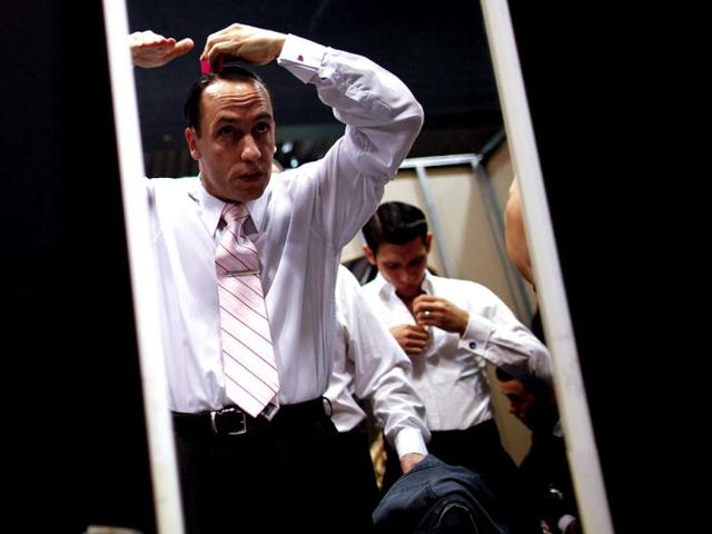 Argentina's dancer Cristian Lopez is seen reflected in a mirror as he combs his hair before competing at the 2012 Tango Dance World Cup salon finals in Buenos Aires, Argentina. Couples from around the world competed in the finals Argentina's annual tango competition, the highlight of a two-week festival which this year honored Astor Piazzolla, the legendary composer and bandoneonista who revived the genre and infuriated purists by blending tango with rock music in the 1970s. (AP Photo/Natacha Pisarenko)