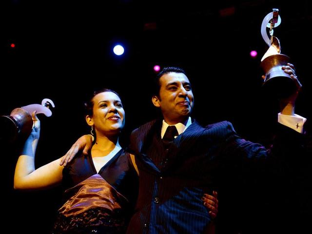 Argentina's Facundo Gomez Cross and Paola Palavecino Florence Sanz hold their trophies after winning the Tango Salon category at the Tango World Championship in Buenos Aires. AFP PHOTO / DANIEL GARCIA