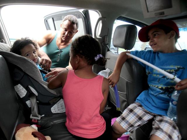 Jaden Fabian (L), is strapped into her car seat by Estanislao Fabian as her family evacuates their home as hurricane Isaac heads towards the Louisiana coast line in Oakville, Louisiana. Reuters Photo Jaden Fabian (L), is strapped into her car seat by Estanislao Fabian as her family evacuates their home as hurricane Isaac heads towards the Louisiana coast line in Oakville, Louisiana. Reuters Photo