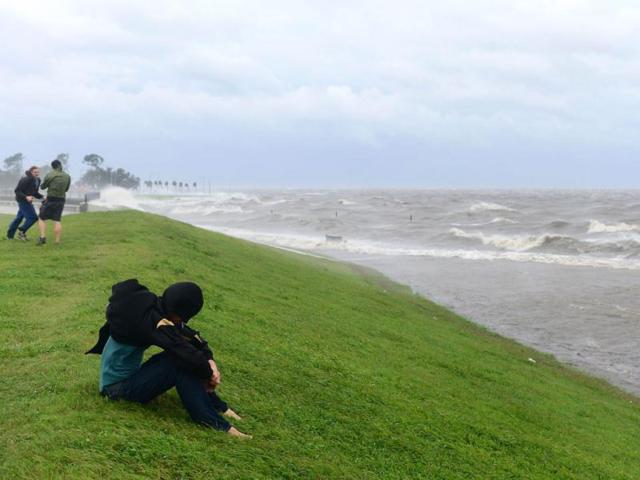 People brave the rain and strong winds for a visit to Lake Pontchartrain in New Orleans, Louisiana, where Hurricane Isaac has made landfall. The US National Hurricane Center said a "dangerous storm surge" was occurring along the northern Gulf Coast with storm surges of up to eight feet (2.4 meters) already being reported in Louisiana, Mississippi and Florida. States of emergency have been declared in Louisiana and Mississippi, allowing authorities to coordinate disaster relief and seek emergency federal funds. AFP PHOTO / Frederic J. BROWN