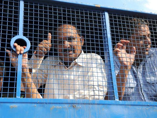 Former leader of Bajrang Dal Babu Bajrangi gestures from the window of a police vehicle in Ahmedabad. AFP Photo