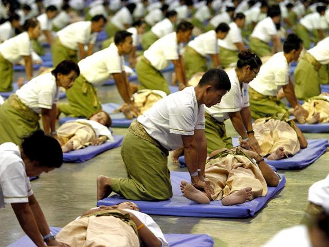 People take part in an attempt to break the world record for mass-massaging in Muang Thong Thanni, Bangkok. (Reuters/Sukree Sukplang)