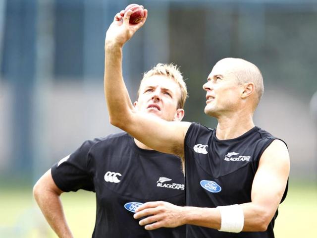 New Zealand cricketer Chris Martin, right, talks to bowling coach Damien Wright during a training session in Bangalore. (AP Photo/Aijaz Rahi)
