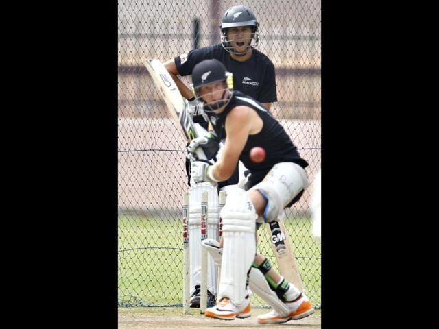 New Zealand captain Ross Taylor, rear, yawns as he watches teammate Martin Guptill bat in the nets during a training session in Bangalore. (AP Photo/Aijaz Rahi)
