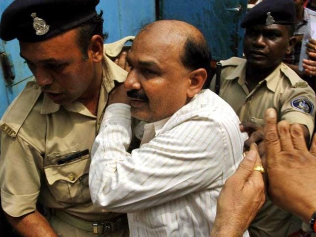 Former Bajrang Dal leader Babu Bajrangi is escorted by policemen on his arrival at a special court in Ahmedabad. AP Photo/Ajit Solanki