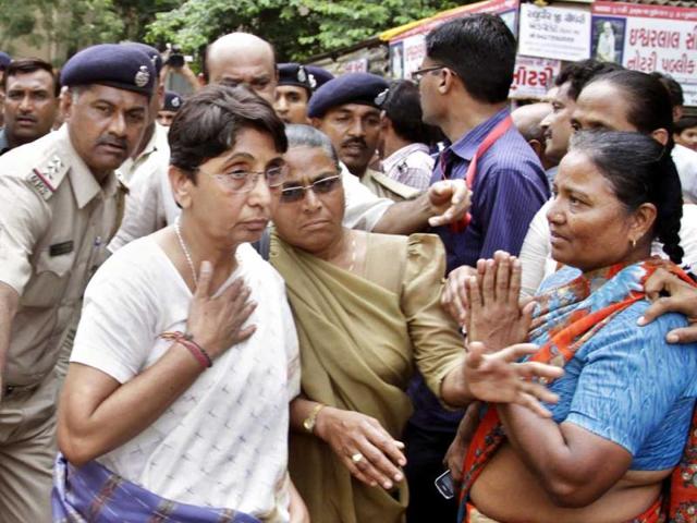 Former Gujarat minister and BJP leader Maya Kodnani is led by police on her arrival at a special court in Ahmedabad. AP Photo/Ajit Solanki
