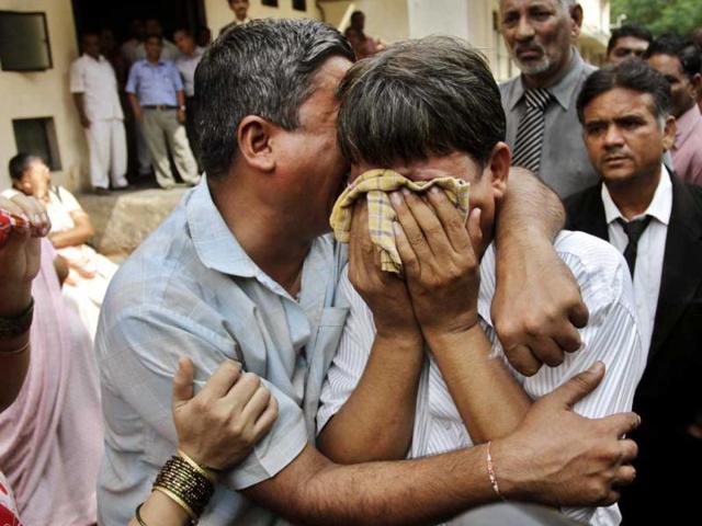 Relatives of the convicts in 2002 Naroda Patiya massacre case, in tears outside the court on the day of pronouncement of sentence in the case, in Ahmedabad. AP Photo/Ajit Solanki