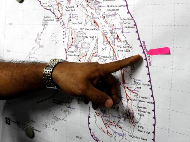 Renato Solidum, head of the seismology agency, points to the location of the quake during a news conference at their head office in Quezon City, Metro Manila. (Reuters)