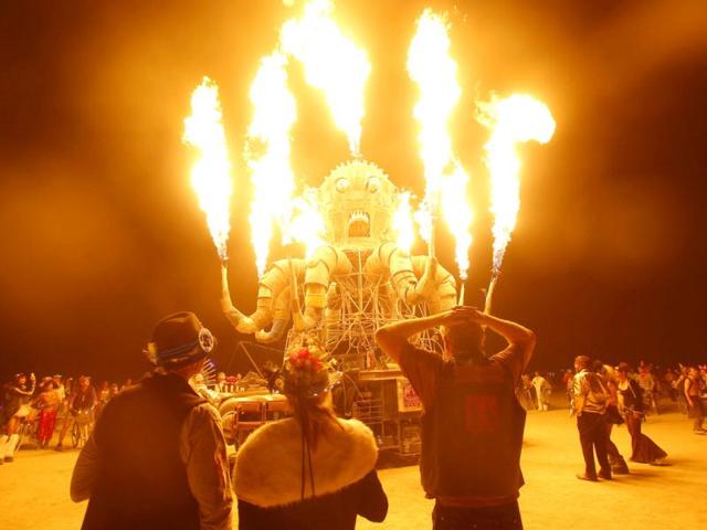 Participants watch the flames from El Pulpo Mecanico during the Burning Man 2012 "Fertility 2.0" arts and music festival in the Black Rock Desert of Nevada.