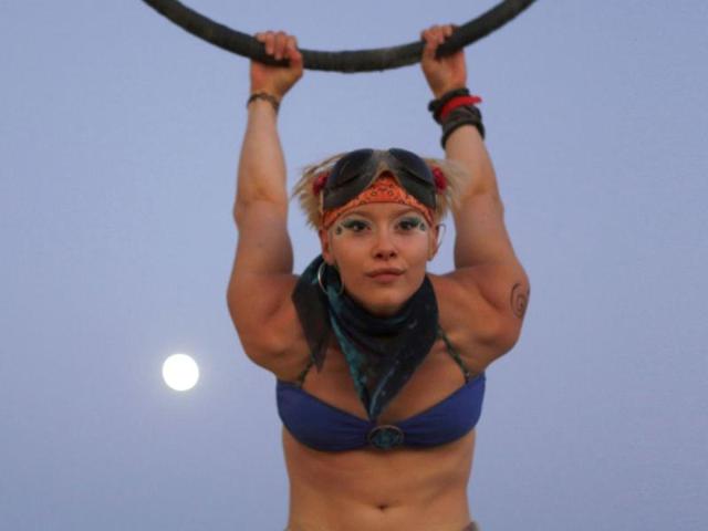 Aerialist Indie-Lou performs during the Burning Man 2012 "Fertility 2.0" arts and music festival in the Black Rock Desert of Nevada. More than 60,000 people from all over the world have gathered at the sold out festival, which is celebrating its 26th year, to spend a week in the remote desert cut off from much of the outside world to experience art, music and the unique community that develops. REUTERS/Jim Urquhart