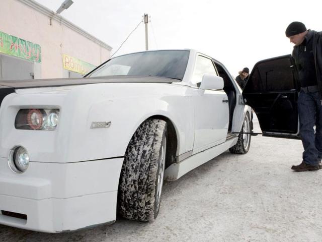 A man inspects car mechanic Ruslan Mukanov's homemade replica of the Rolls-Royce Phantom in Shakhtinsk town, about 200 km south of the capital Astana. (Reuters/Valery Kaliev)