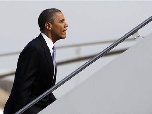 US President Barack Obama board Air Force One at Andrews Air Force Base, Md., en route to Ohio. AP Photo/Carolyn Kaster