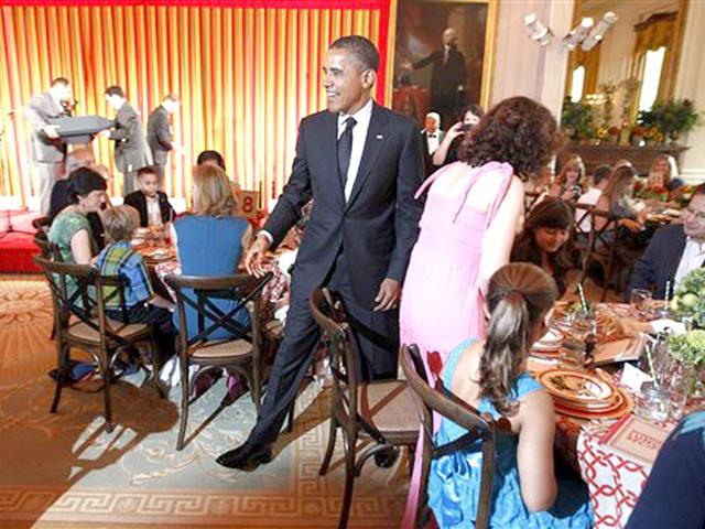 US President Barack Obama greet guests arrive at the first ever Kids’ "State Dinner" Luncheon in the East Room of the White House in Washington, hosted by first lady Michelle Obama. AP Photo/Pablo Martinez Monsivais