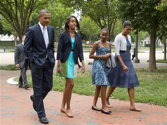 US President Barack Obama with first lady Michelle Obama and their daughters Sasha and Malia, second from left, walk from the White House in Washington to a nearby church to attend services. AP Photo/Manuel Balce Ceneta