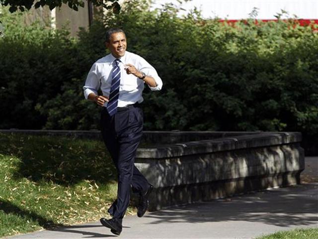 US President Barack Obama runs to take the stage during campaign stop on the campus of Colorado State University in Fort Collins. AP Photo/David Zalubowski