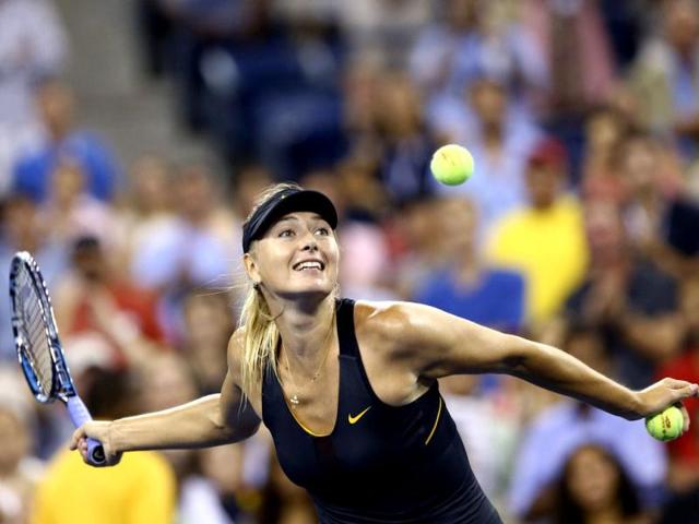 Maria Sharapova of Russia hits tennis balls into the crowd after defeating Nadia Petrova of Russia following their match at the US Open women's singles tennis tournament in New York. Reuters/Adam Hunger
