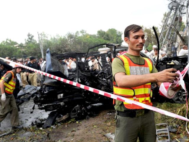 Pakistani security personnel cordon off the area around a bomb blast site in Peshawar. AFP Photo/A Majeed