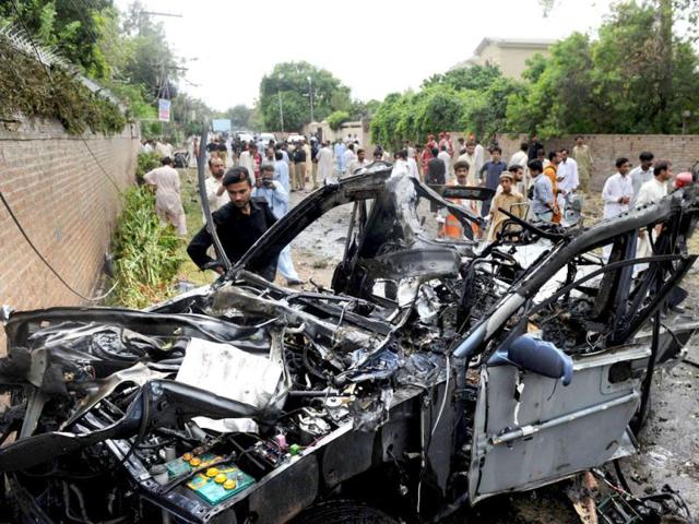 Pakistani rescuers and security personnel gather at a bomb blast site in Peshawar. AFP Photo/A Majeed