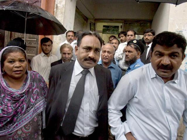 Tahir Naveed Chaudhry, center, lawyer of Christian girl accused of blasphemy, leaves after court hearing in Islamabad. AP Photo/Anjum Naveed