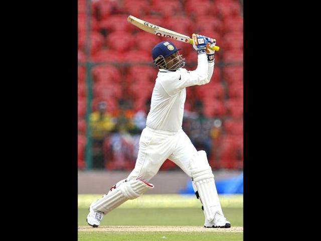 Virender Sehwag watches his shot during the fourth day of the second cricket Test match against New Zealand in Bangalore. (AP Photo/Aijaz Rahi)