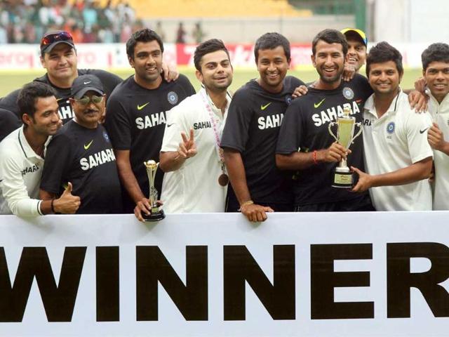 Indian team players and officials pose for photographers as they jubilate after winning the 2nd Test match to win the two test match series against New Zealand 2-0, in Bangalore. (PTI Photo by Shailendra Bhojak)