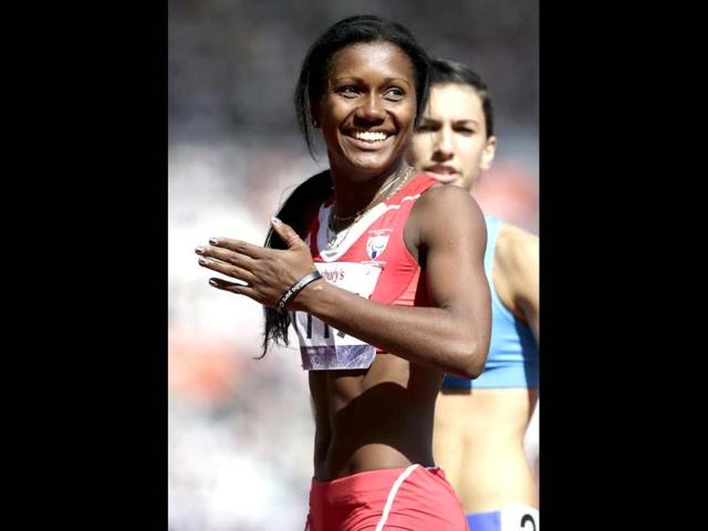 Yunidis Castillo of Cuba reacts after she won her women's 100-meter T46 heat at the 2012 Paralympics games in London. (AP Photo/Alastair Grant)
